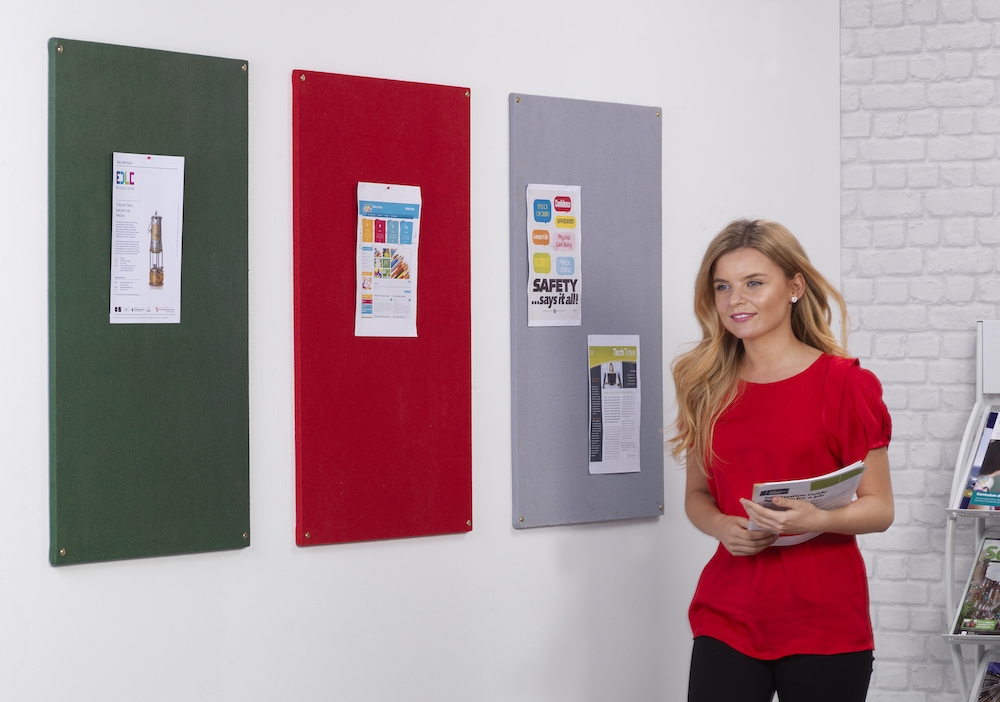 3 colourful school notice boards on wall with teacher