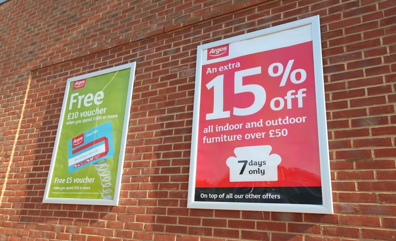 Argos poster outside shop on wall - example of red17 poster case