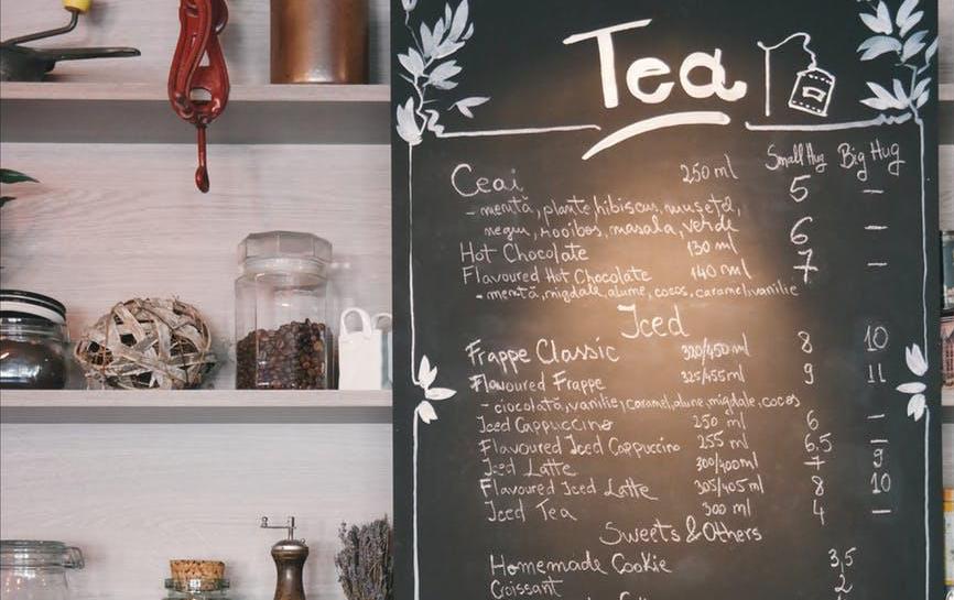 Chalkboard sign in a tea room displaying menu