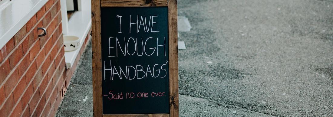 Pavement sign with - I Have Enough Handbags written on chalkboard