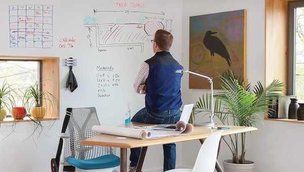 Guy in Office at Home with Whiteboard on Wall