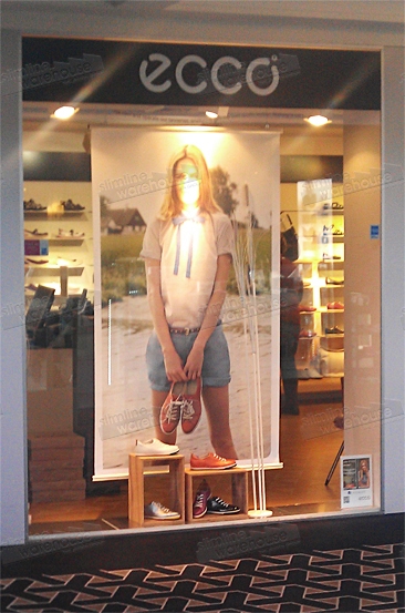 Example of hanging poster rails in retail shop window